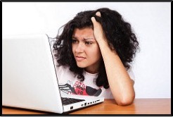 A girl is using a white laptop